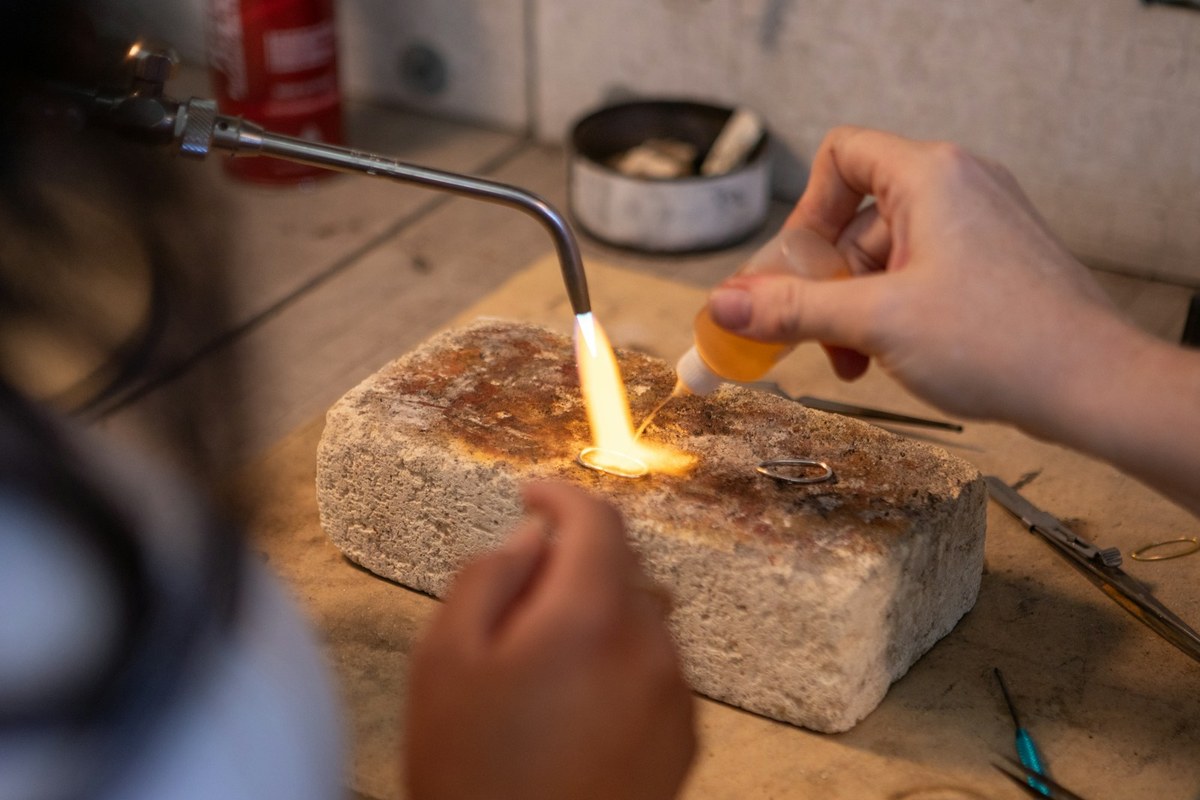 Jeweller soldering a ring at the Grafton Street workshop bench